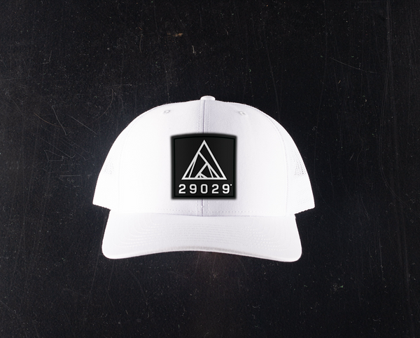 white trucker hat with black patch with a white 29029 lockup logo on the patch.