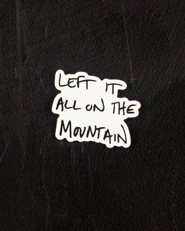 Handwritten sticker in black that reads