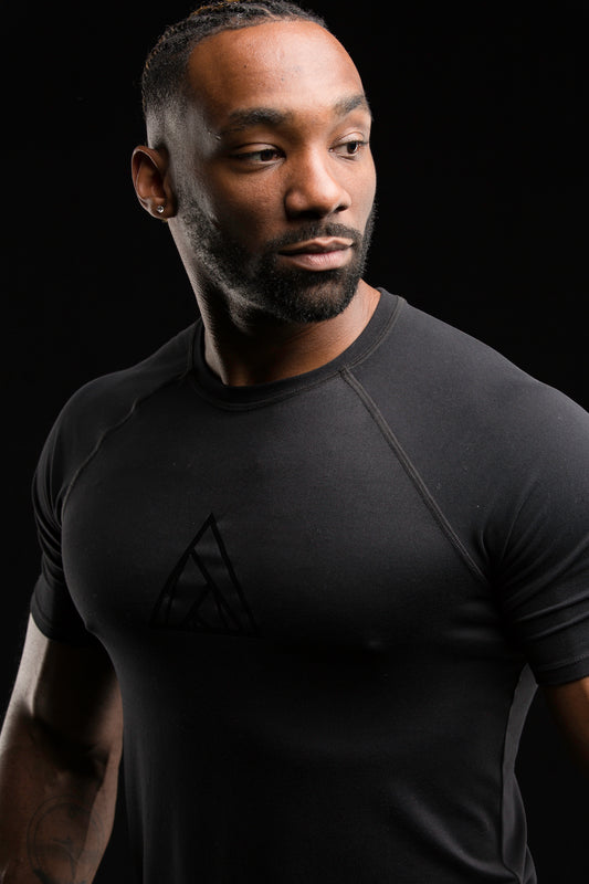 Black performance men's tee with a 29029 triangle logo on the center chest that is reflective black.