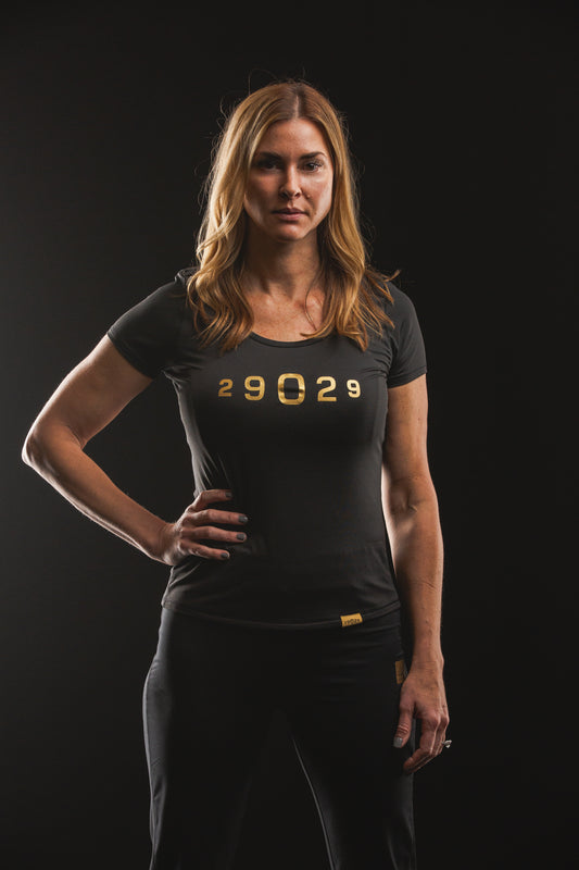 Black performance short sleeve with a gold numeric 29029 logo on the center chest. 