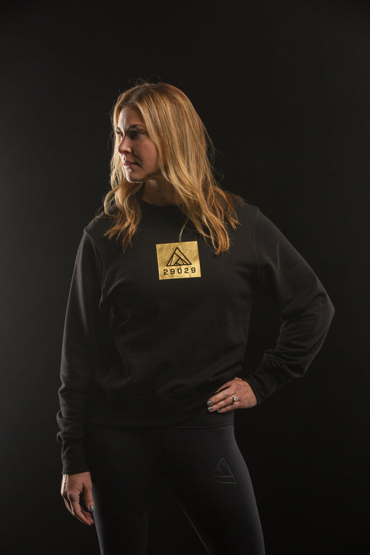 Black sweatshirt with a square gold screen print with the 29029 logo on the center chest.