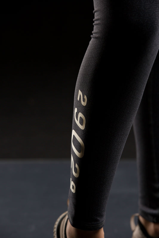 Black leggings with a repeating 29029 triangle logo covering the leggings. features a numeric 29029 down the right calf. 